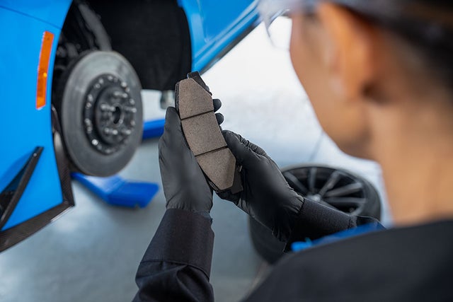 Service Technician inspecting a brake pad